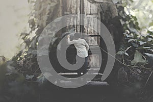 Traveling woman looking for shelter in a tree house in a surreal forest