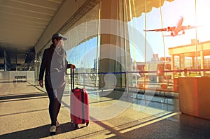 Traveling woman and luggage walking in airport terminal and air