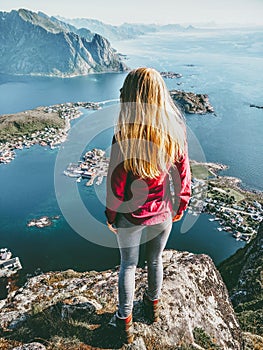 Traveling Woman on Reinebringen mointain over fjord