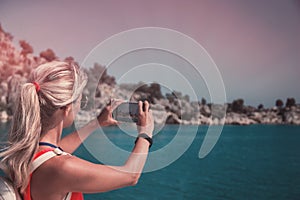 Traveling woman take a photo mountain view, travel concept