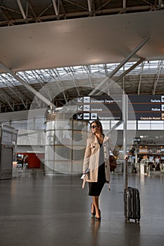 Traveling woman waiting at flight gates for plane boarding