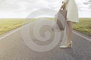 Traveling woman waits with her suitcase to leave for a new journey