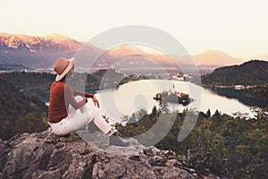 Traveling young woman looking at Bled Lake, Slovenia, Europe