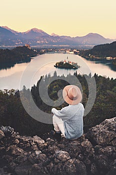 Traveling young woman looking at Bled Lake, Slovenia, Europe