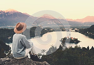 Traveling young woman looking at Bled Lake, Slovenia, Europe