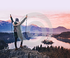 Traveling young woman looking on sunset on Bled Lake, Slovenia,