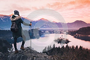 Traveling young woman looking on sunset on Bled Lake, Slovenia,