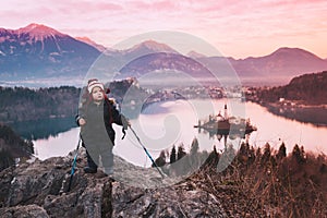 Traveling young woman looking on sunset on Bled Lake, Slovenia,