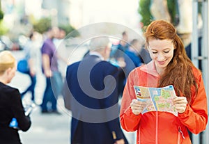 Traveling young Woman reading a Map