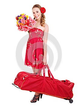 Traveling young woman with wheeled luggage