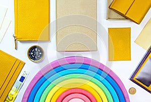 Travell and shopping concept with yellow wallets, 20 euro banknote, compass, coin, children toy rainbow and accessories