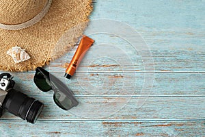 Traveller accessories in summer on wood table, view from above table