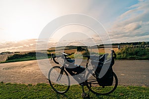 Traveller on bicycle. Solo travel long distance bicycle touring concept