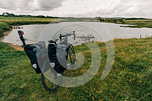 Traveller on bicycle. Solo travel long distance bicycle touring concept