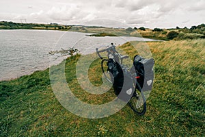 Traveller on bicycle. Solo travel long distance bicycle touring concept