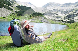 Traveller enjoying the view and relaxing at mountain site.