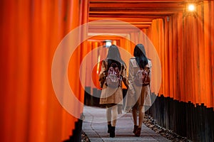 Traveller girl walk togater in Fushimi temple