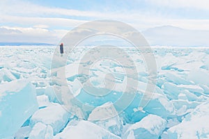 Traveller looks to a field of ice covering Baikal lake in winter.