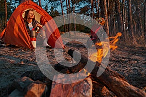 Traveller making tea with burner and camping tableware