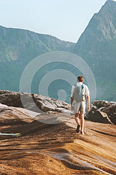 Traveller man hiking alone outdoor in mountains travel solo adventure tour