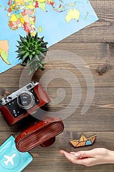 Traveller set with camera and map on wooden background top view mock-up