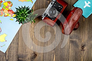 traveller set with camera and map on wooden background top view mock-up