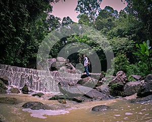 Traveller Stading On A Rock At Kathu Waterfall