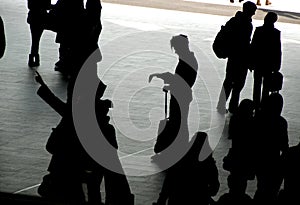 Travellers silhouetted on station concourse photo