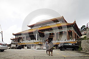 Traveller thai woman asking malaysian people at front of Kek Lok Si Chinese and Buddhist temple