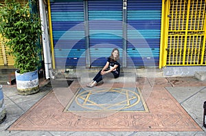 Traveller thai woman sit and portrait at front of colorful steel