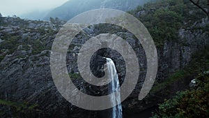 Traveller tourist look over waterfall, drone shot