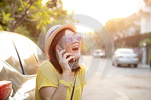 Traveller woman laughing with happiness face standing on back of suv car