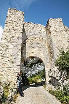 Traveller woman posing in entrance gate of castle ruins Hainburg an der Donau