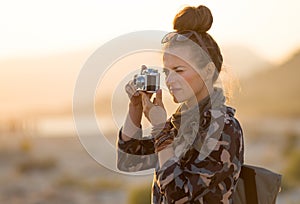 Traveller woman taking photos with retro photo camera