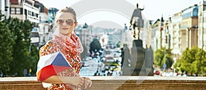 Traveller woman on Vaclavske namesti in Prague with Czech flag