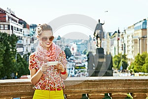 Traveller woman on Vaclavske namesti in Prague writing sms photo