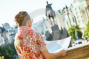 Traveller woman on Wenceslas Square in Prague with map