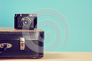 Travelling background. Vintage travel. Blogging. Leather retro suitcase and camera for travel, trip. Tourism concept