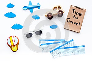 Travelling with child concept. Airplan toy, air balloon cookie, airplan tickets. Time to travel hand lettering in