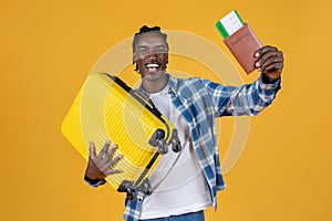 Travelling Concept. Portrait Of Happy Black Young Man With Suitcase And Passport