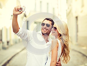 Travelling couple taking photo picture with camera