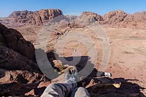 Travelling, hiking and adventurous in desert Middle-East. Traveler enjoying high angle view of desert landscape in Jordan