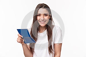 Travelling, holidays, summer concept. Close-up portrait of cute, happy pretty young woman in t-shirt, holding opened