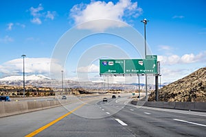 Travelling on the interstate towards Reno; the city`s downtown visible in the background; Nevada