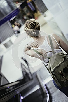 Travelling scene at a train station: young girl and a stairway