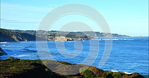 Travelling shot of the coast of the Basque Country near Hendaye with its cliffs and its twin rocks