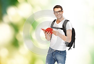 Travelling student with backpack and book