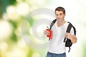 Travelling student with backpack and book