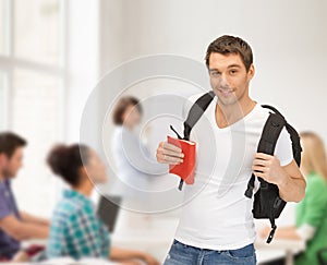 Travelling student with backpack and book