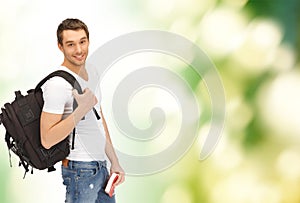 Travelling student with backpack and book